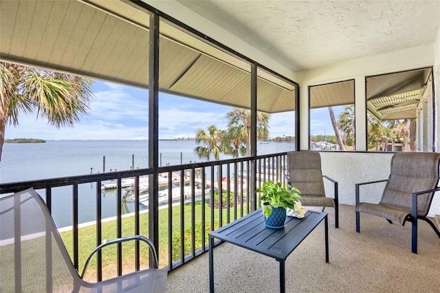 sunroom / solarium with a water view