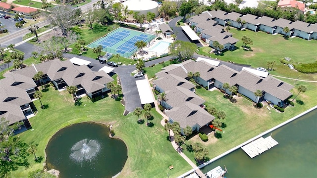 aerial view of property's location featuring a nearby body of water and nearby suburban area