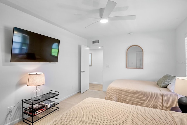 bedroom featuring light carpet, baseboards, and a ceiling fan