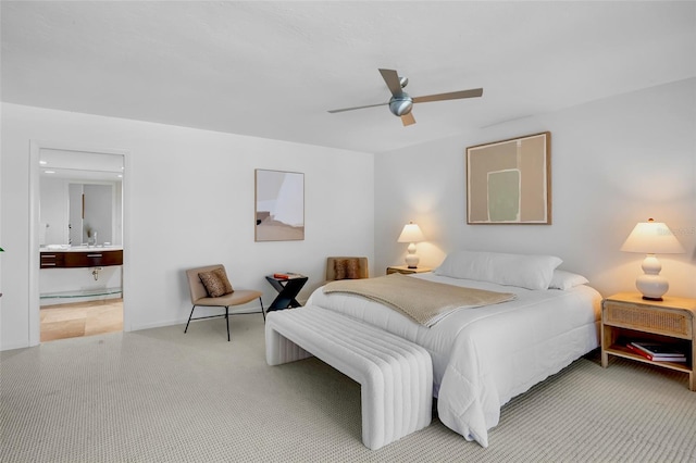 bedroom featuring carpet floors, ensuite bath, ceiling fan, and baseboards