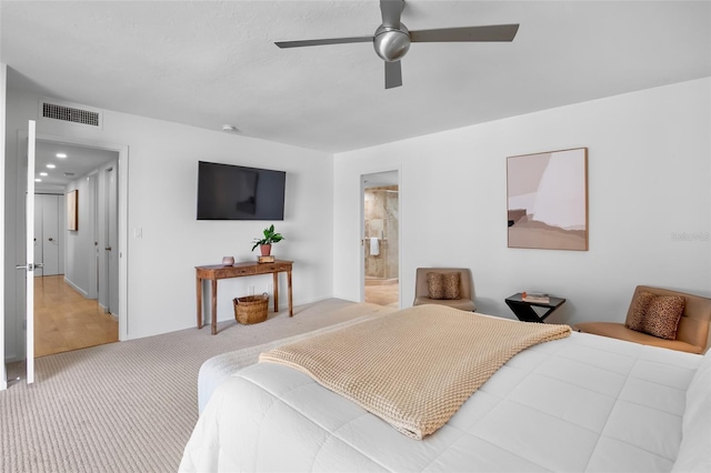 bedroom featuring carpet, ceiling fan, and connected bathroom