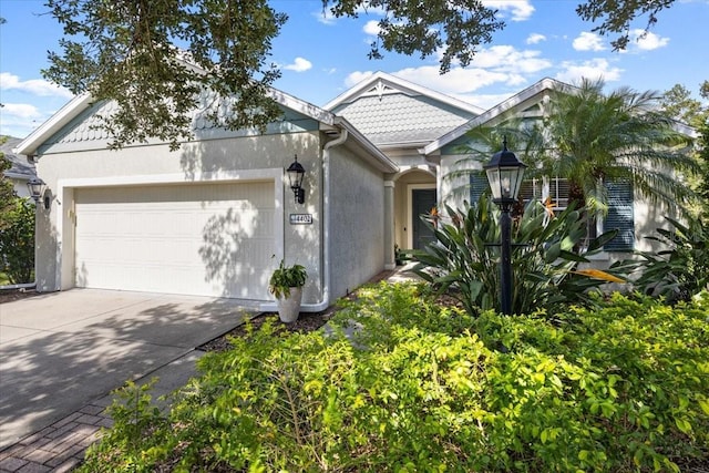 4402 Natures Reach Ter, Parrish, FL 34219 - victorian home featuring a garage, concrete driveway, and stucco siding