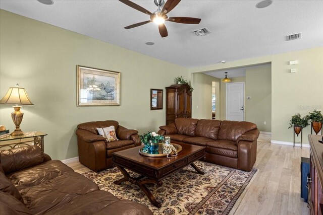4402 Natures Reach Ter, Parrish, FL 34219 - living room featuring a ceiling fan, light wood finished floors, and baseboards