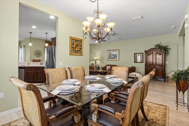 4402 Natures Reach Ter, Parrish, FL 34219 - dining room featuring a chandelier, light wood-style flooring, recessed lighting, and baseboards