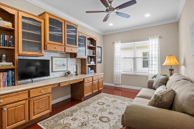 4402 Natures Reach Ter, Parrish, FL 34219 - home office featuring built in study area, ceiling fan, dark wood-style flooring, baseboards, and crown molding