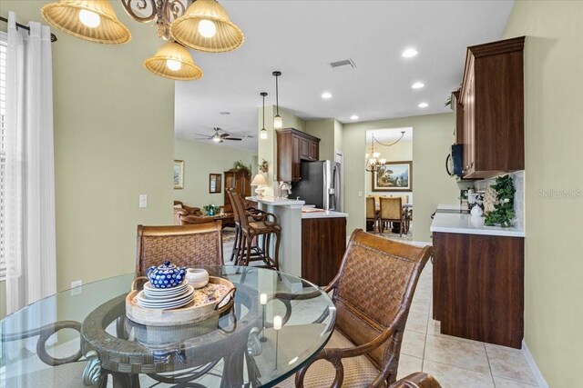 4402 Natures Reach Ter, Parrish, FL 34219 - dining room featuring ceiling fan, a chandelier, light tile patterned floors, recessed lighting, and baseboards