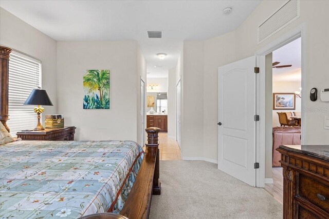 4402 Natures Reach Ter, Parrish, FL 34219 - bedroom with light carpet and connected bathroom