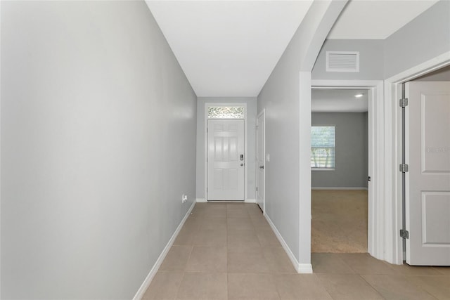 12712 Dusty Trail Dr, Sarasota, FL 34238 - corridor with light tile patterned floors, baseboards, and arched walkways