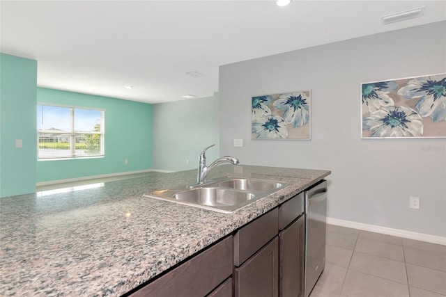 12712 Dusty Trail Dr, Sarasota, FL 34238 - kitchen featuring a sink, baseboards, dishwasher, dark brown cabinets, and light stone countertops