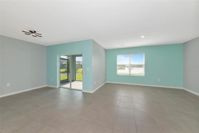 12712 Dusty Trail Dr, Sarasota, FL 34238 - unfurnished room featuring healthy amount of natural light, baseboards, and tile patterned floors