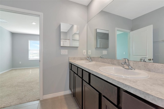 12712 Dusty Trail Dr, Sarasota, FL 34238 - bathroom featuring double vanity, baseboards, and tile patterned floors