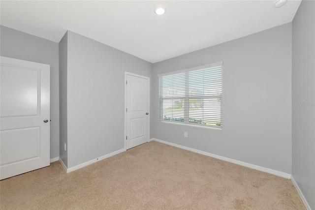 12712 Dusty Trail Dr, Sarasota, FL 34238 - unfurnished bedroom with light carpet, baseboards, and recessed lighting