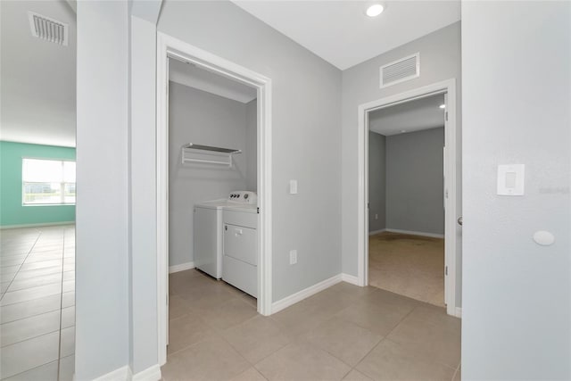 12712 Dusty Trail Dr, Sarasota, FL 34238 - hall featuring washer and dryer, light tile patterned floors, and baseboards