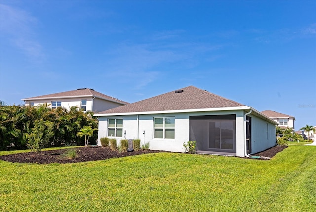 12712 Dusty Trail Dr, Sarasota, FL 34238 - back of house with a yard, stucco siding, and a shingled roof