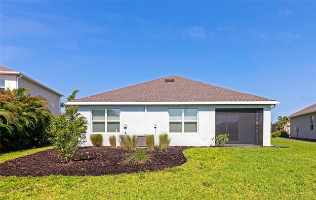 12712 Dusty Trail Dr, Sarasota, FL 34238 - rear view of house featuring stucco siding, a yard, a shingled roof, and a sunroom