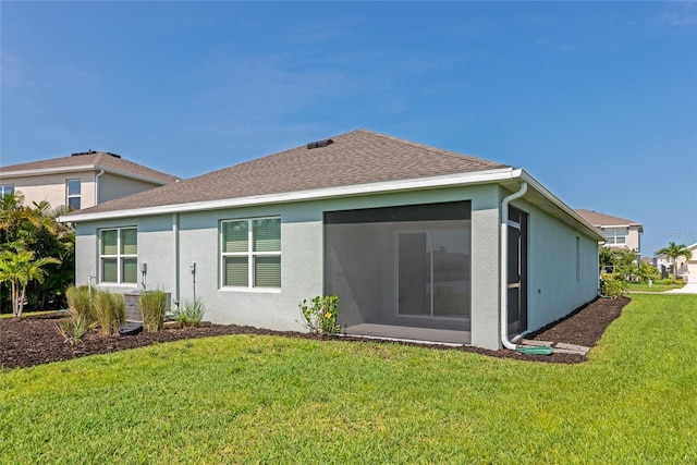 12712 Dusty Trail Dr, Sarasota, FL 34238 - rear view of house featuring a yard, roof with shingles, and stucco siding