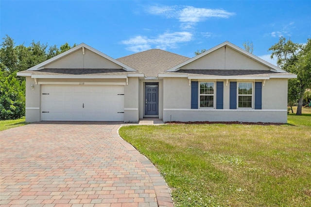 27519 Pasto Dr, Punta Gorda, FL 33983 - ranch-style home featuring decorative driveway, an attached garage, a front lawn, and stucco siding