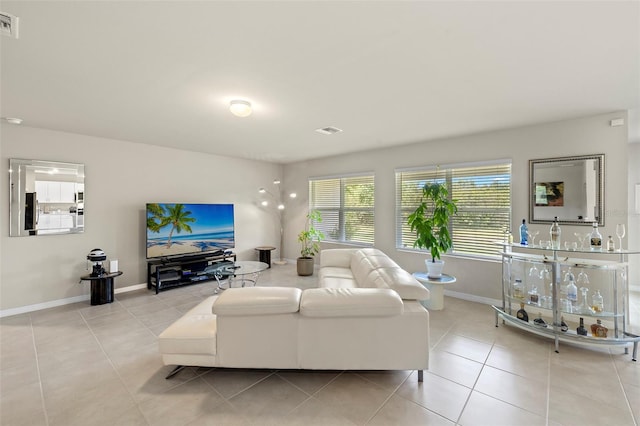 27519 Pasto Dr, Punta Gorda, FL 33983 - living area with baseboards, light tile patterned flooring, and a dry bar