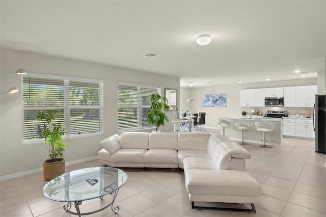 27519 Pasto Dr, Punta Gorda, FL 33983 - living room with light tile patterned flooring, baseboards, and recessed lighting