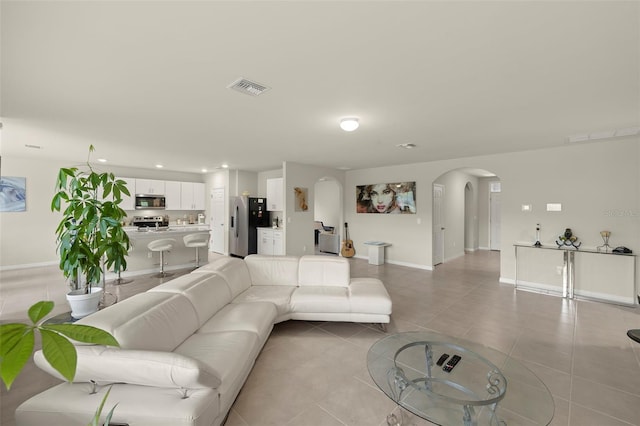 27519 Pasto Dr, Punta Gorda, FL 33983 - living area featuring arched walkways, baseboards, light tile patterned floors, and recessed lighting