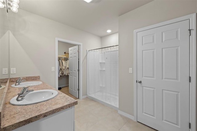 27519 Pasto Dr, Punta Gorda, FL 33983 - full bath featuring a stall shower, baseboards, a spacious closet, tile patterned floors, and double vanity