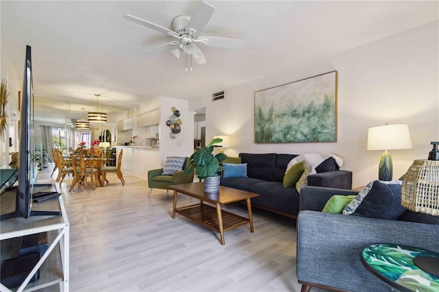 3269 Beneva Rd Unit 103, Sarasota, FL 34232 - living area featuring light wood finished floors and a ceiling fan