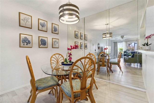3269 Beneva Rd Unit 103, Sarasota, FL 34232 - dining room with a chandelier, a ceiling fan, and baseboards