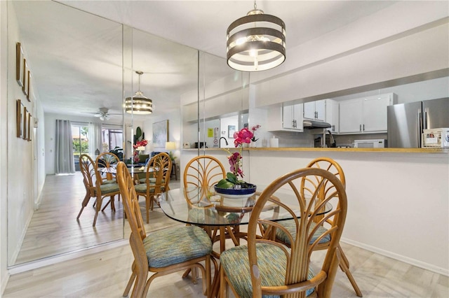3269 Beneva Rd Unit 103, Sarasota, FL 34232 - dining area with a chandelier, ceiling fan, and baseboards
