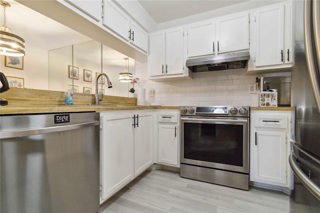 3269 Beneva Rd Unit 103, Sarasota, FL 34232 - kitchen with appliances with stainless steel finishes, extractor fan, and white cabinets