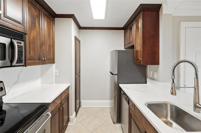 4037 Crockers Lake Blvd Unit 14, Sarasota, FL 34238 - kitchen featuring stainless steel appliances, ornamental molding, light stone countertops, and light tile patterned flooring