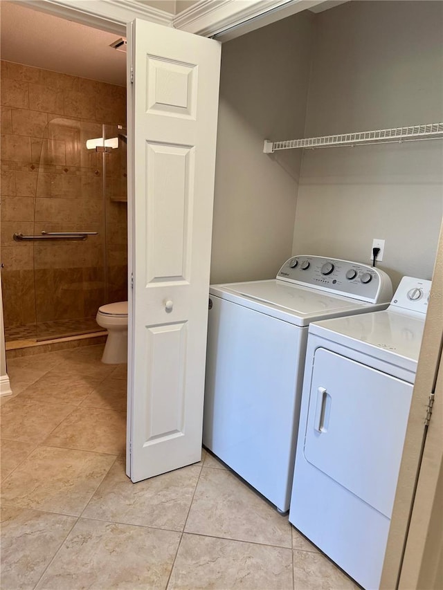 4037 Crockers Lake Blvd Unit 14, Sarasota, FL 34238 - laundry area featuring washer and dryer and light tile patterned flooring