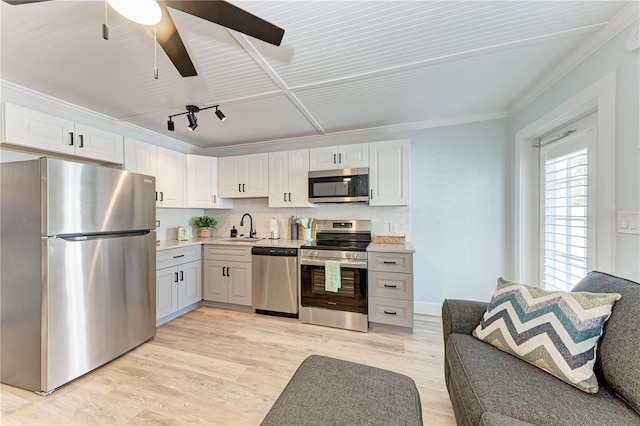 301 Highland Ave Unit 3, Bradenton Beach, FL 34217 - kitchen featuring appliances with stainless steel finishes, a sink, ceiling fan, light countertops, and tasteful backsplash