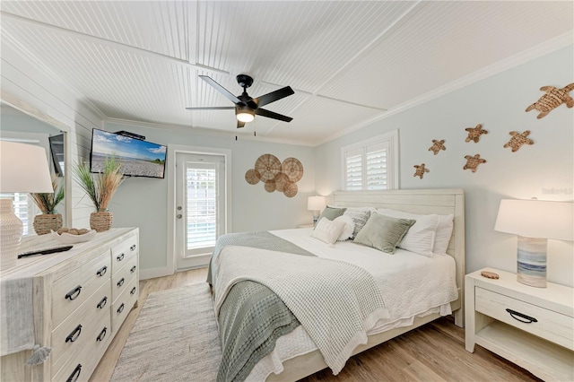 301 Highland Ave Unit 3, Bradenton Beach, FL 34217 - bedroom with access to exterior, crown molding, multiple windows, light wood-style floors, and a ceiling fan