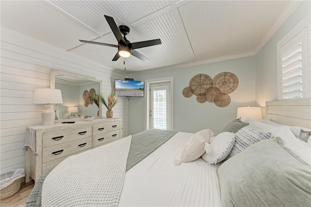 301 Highland Ave Unit 3, Bradenton Beach, FL 34217 - bedroom with light wood finished floors, ornamental molding, a ceiling fan, and wood walls