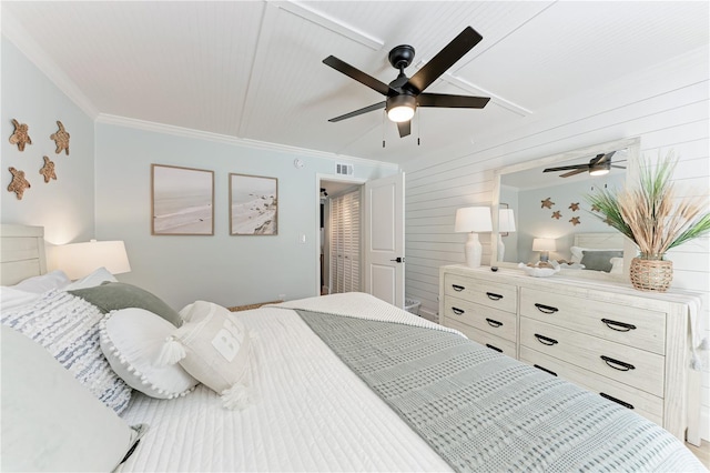 301 Highland Ave Unit 3, Bradenton Beach, FL 34217 - bedroom with ornamental molding, wooden walls, and a ceiling fan
