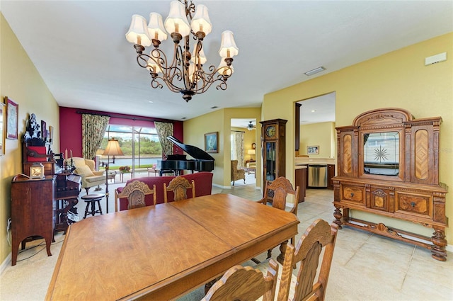 dining area featuring a chandelier, light tile patterned floors, and baseboards