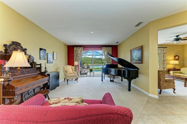 sitting room with baseboards, carpet floors, and ceiling fan