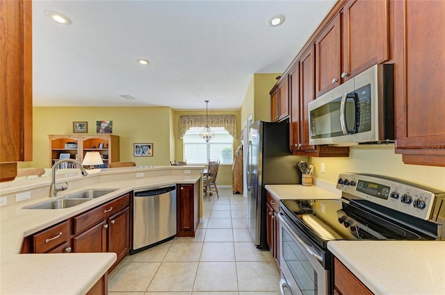 kitchen featuring appliances with stainless steel finishes, a sink, light countertops, reddish brown cabinets, and light tile patterned floors