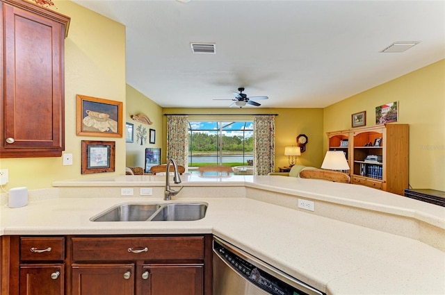 kitchen with a sink, open floor plan, dishwasher, ceiling fan, and light countertops