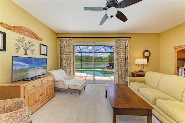 living room featuring a ceiling fan, a sunroom, and light carpet