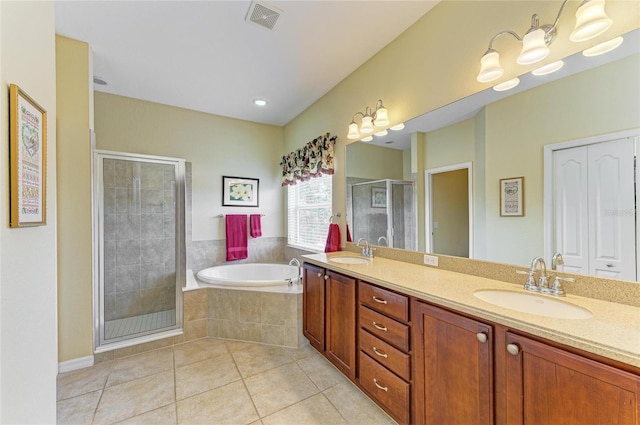 full bath featuring a stall shower, tile patterned flooring, a bath, and double vanity