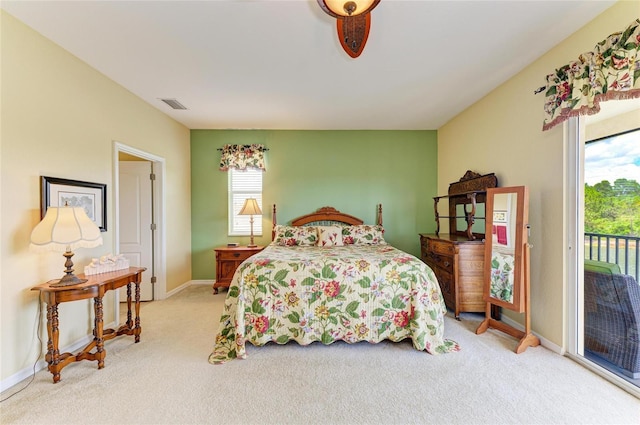 bedroom with access to exterior, light carpet, and baseboards