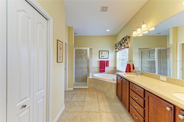 full bath featuring tile patterned floors, a shower stall, a garden tub, and double vanity