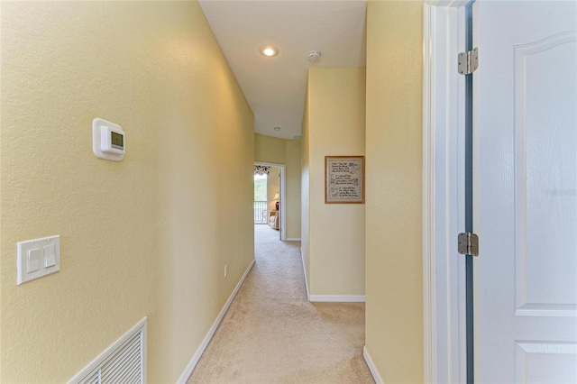 hallway with light carpet, baseboards, and recessed lighting