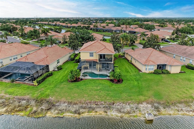 aerial view of residential area featuring a large body of water and a pool
