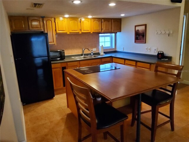 4607 W N B St Unit 105, Tampa, FL 33609 - kitchen featuring black appliances, dark countertops, recessed lighting, and light tile patterned floors