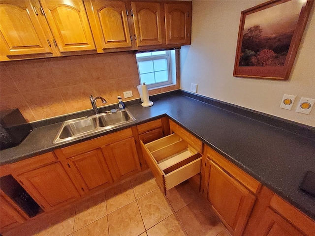 4607 W N B St Unit 105, Tampa, FL 33609 - kitchen featuring brown cabinets, light tile patterned flooring, and dark countertops
