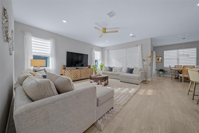 6185 SW 89th Ct, Ocala, FL 34481 - living area featuring light wood finished floors, ceiling fan, healthy amount of natural light, recessed lighting, and baseboards