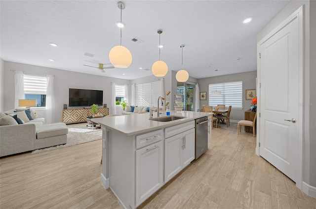 6185 SW 89th Ct, Ocala, FL 34481 - kitchen featuring stainless steel dishwasher, a sink, open floor plan, light wood-style flooring, and recessed lighting