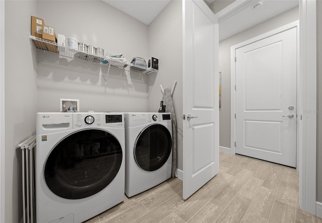 6185 SW 89th Ct, Ocala, FL 34481 - laundry room with light wood-style flooring, washer and clothes dryer, and baseboards